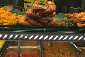 Malaysian hawker center food counter with fresh seafood and local cuisine