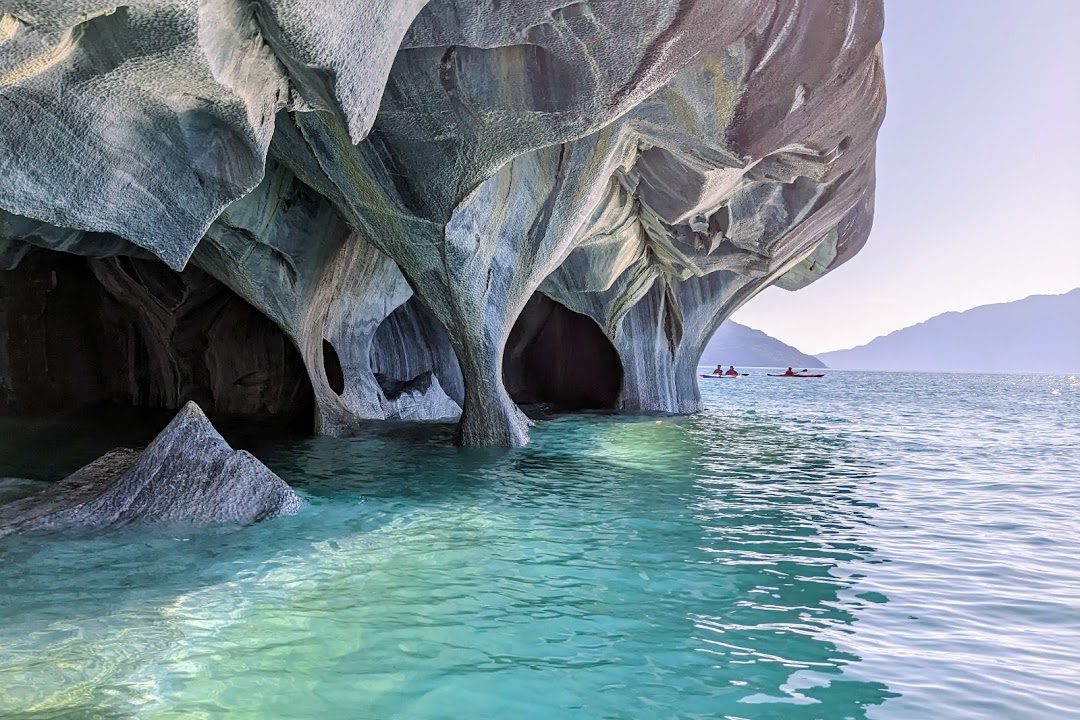 Boat passing the blue marble rock formations of the Marble Caves on Lago General Carrera