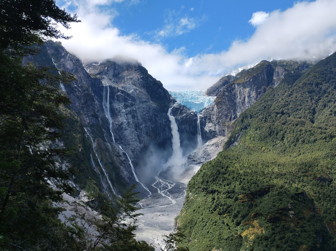 Queulat National Park hanging glacier above forest and waterfalls in Chilean Patagonia